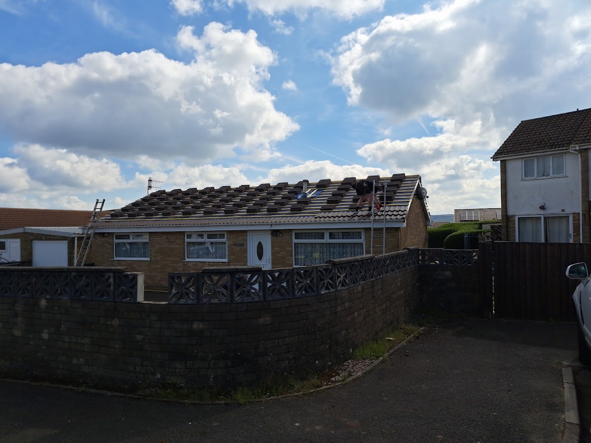 Bungalow mid re-roof with new tiles stacked across the battens